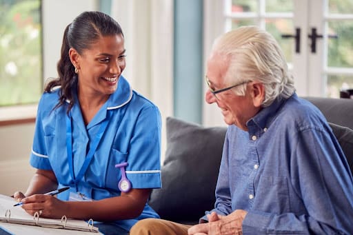 senior man with dementia talking to caregiver